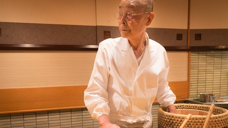 Famous sushi chef Jiro Ono works in his restaurant kitchen