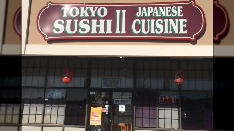 The exterior of Tokyo II, a red and white sign on the top of the building