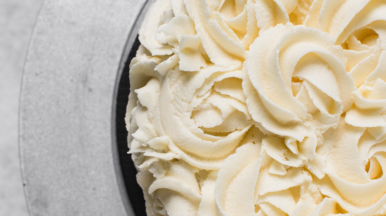 Close up image of buttercream rosettes on a cake
