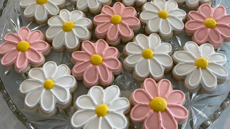 Floral sugar cookies on a glass cake stand