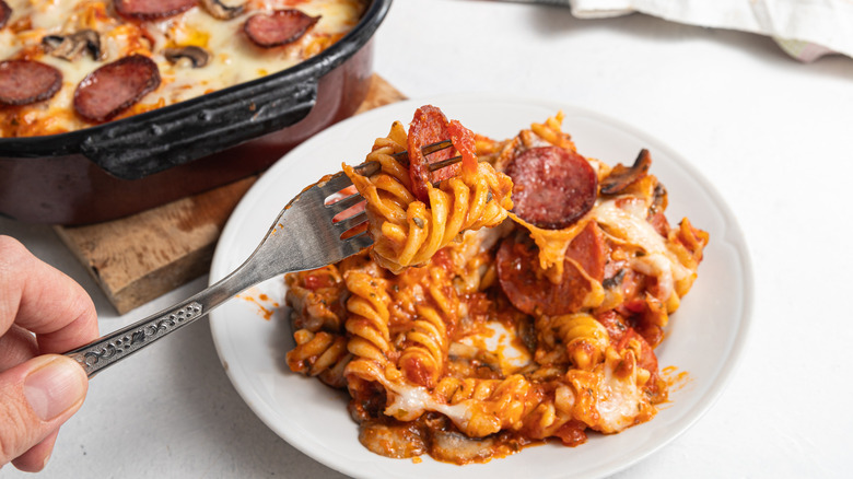 holding fork over pepperoni pasta bake
