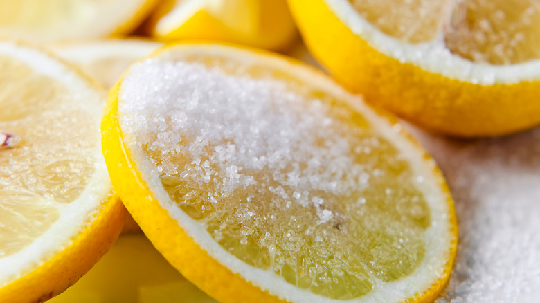 Fresh lemon sliced are sprinkled with sugar